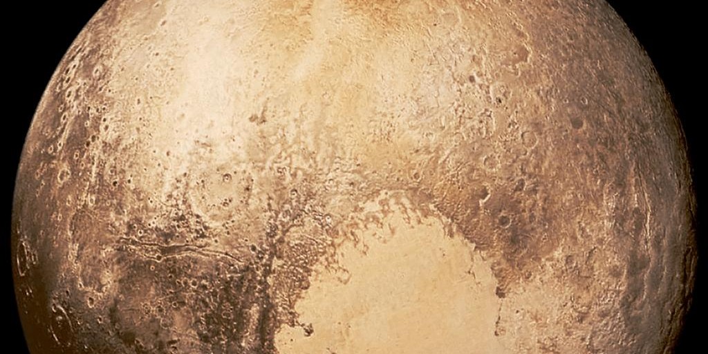 Global View Of Pluto With Its Bright Heart-Shaped Tombaugh Regio